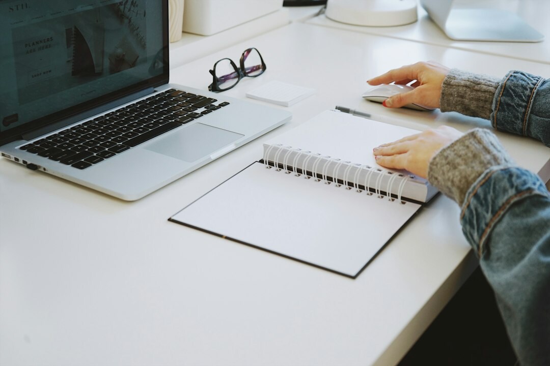 author writing at desk with notebook